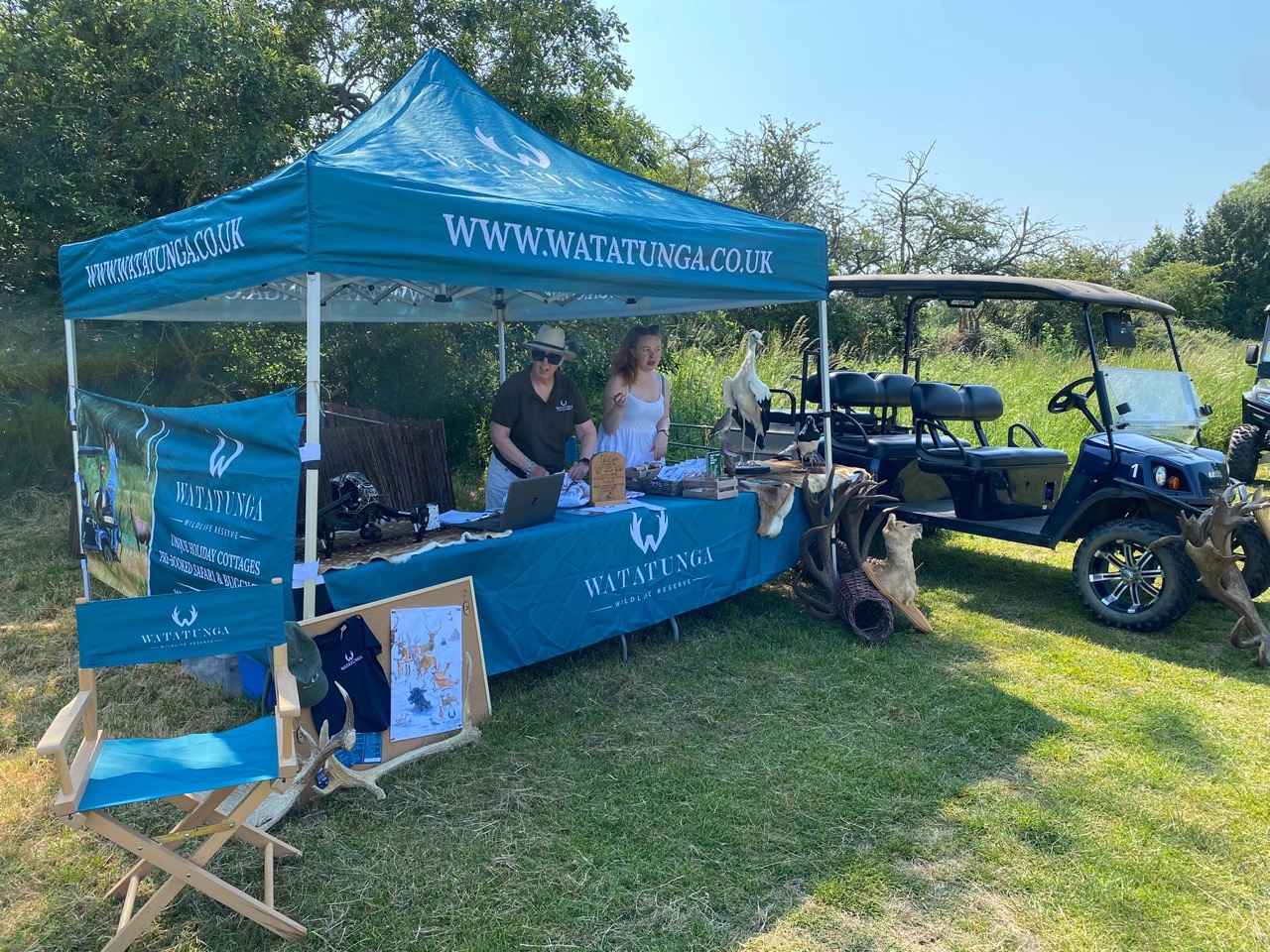 A gazebo with Watatunga branding set up at a vilage fete