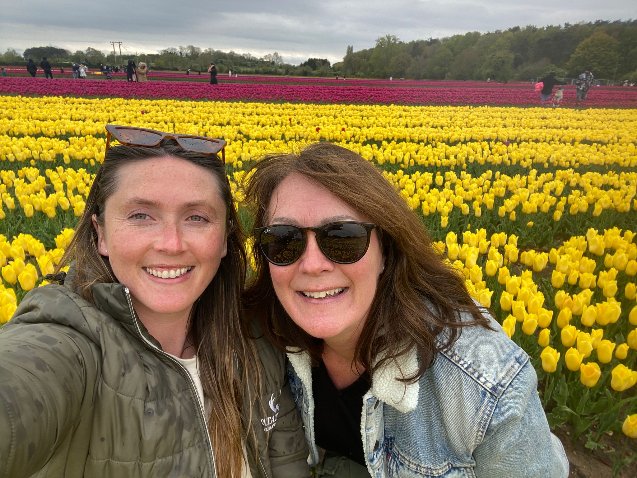 Two women in a field of tulips