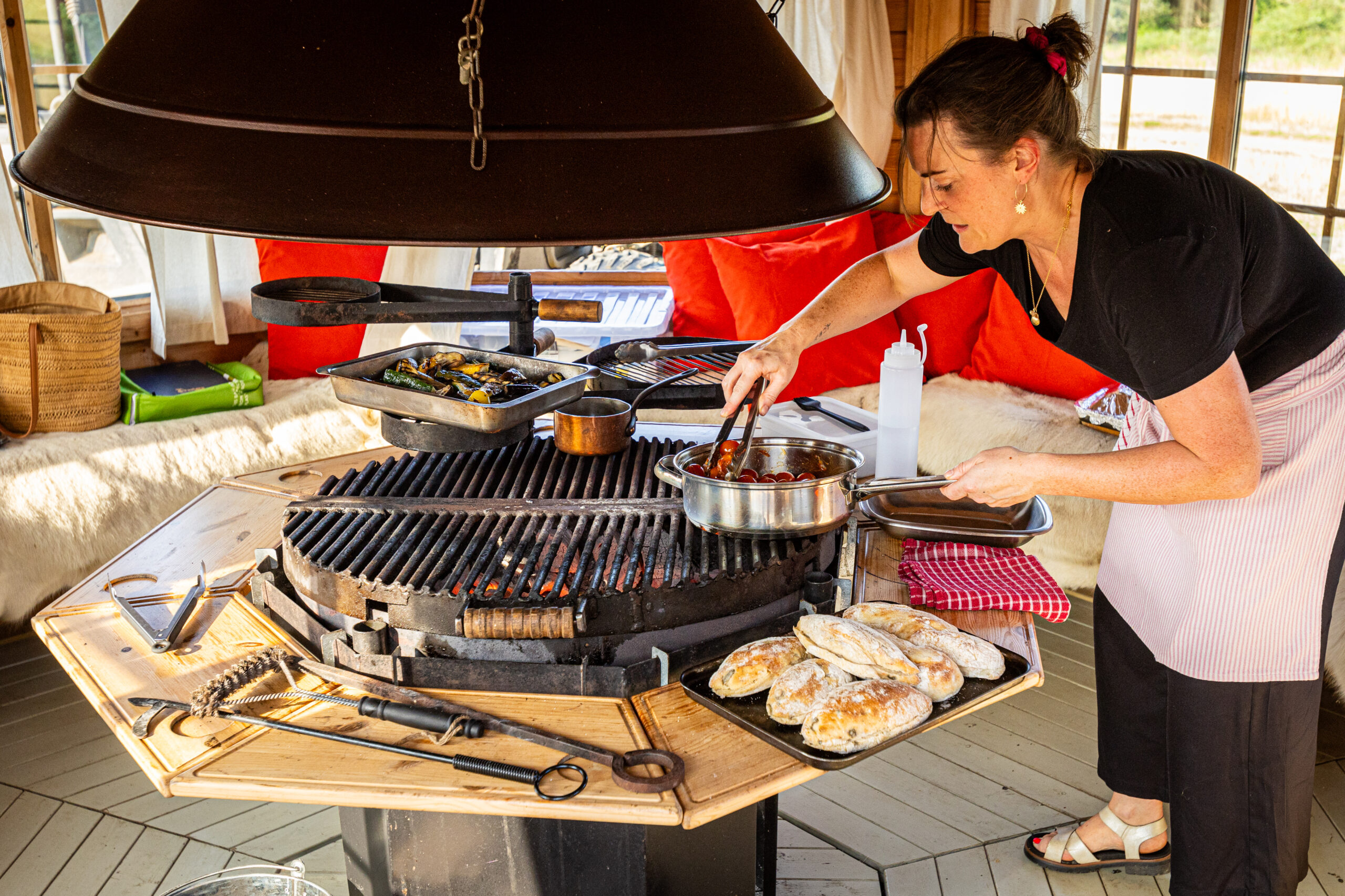 Chef Lucy Cheyney cooking in the BBQ hut