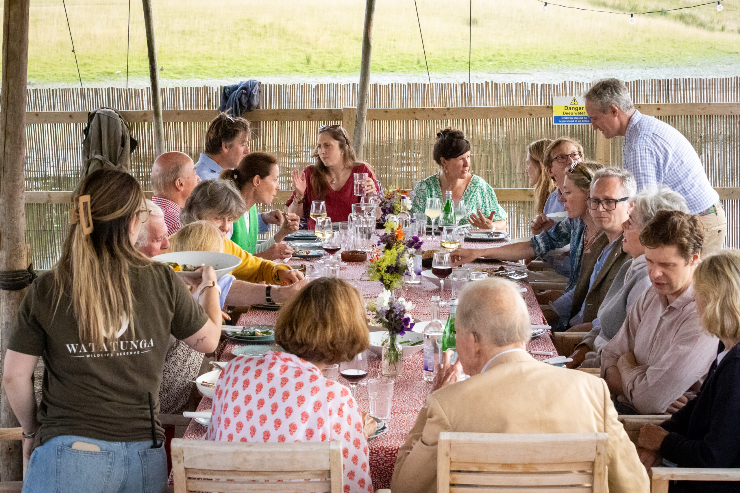 Guests around a communal table, enjoying delicious food